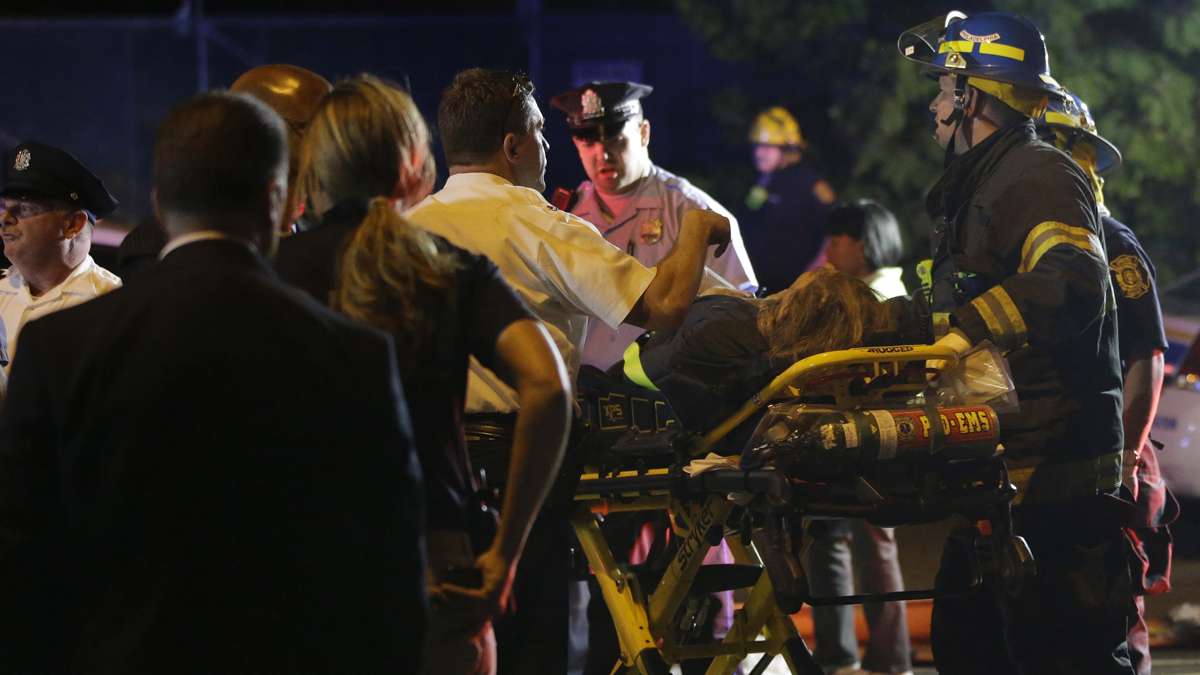 Emergency personnel transport a person at the scene of a train wreck, Tuesday, May 12, 2015, in Philadelphia. An Amtrak train headed to New York City derailed and crashed in Philadelphia.