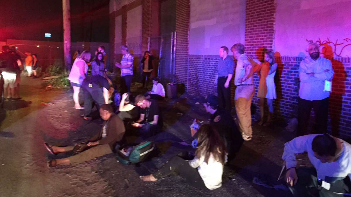 Passengers of an Amtrak train that crashed gather Tuesday, May 12, 2015, near Philadelphia. Train 188 was traveling from Washington to New York City.