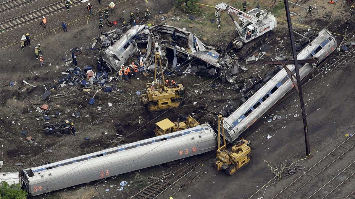 Emergency personnel work at the scene of a deadly train derailment, Wednesday, May 13, 2015, in Philadelphia. The Amtrak train, headed to New York City, derailed and crashed in Philadelphia on Tuesday night, killing at least six people and injuring dozens of others. (Patrick Semansky/AP Photo)