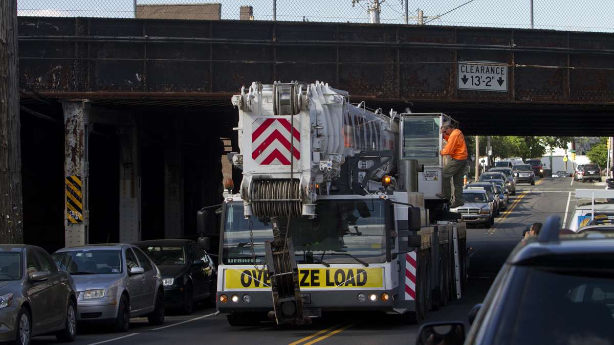 Emergency personnel bring in a crane to move the derailed Amtrak train near Port Richmond in North Philadelphia Wednesday morning.