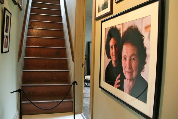 The two bedrooms above the Wyeth studio are closed to the public. The hallway leading to the stairs holds many family photographs, including this one of Andrew Wyeth's sister, Ann Wyeth McCoy and niece, Anna B. McCoy. (Emma Lee/for NewsWorks)