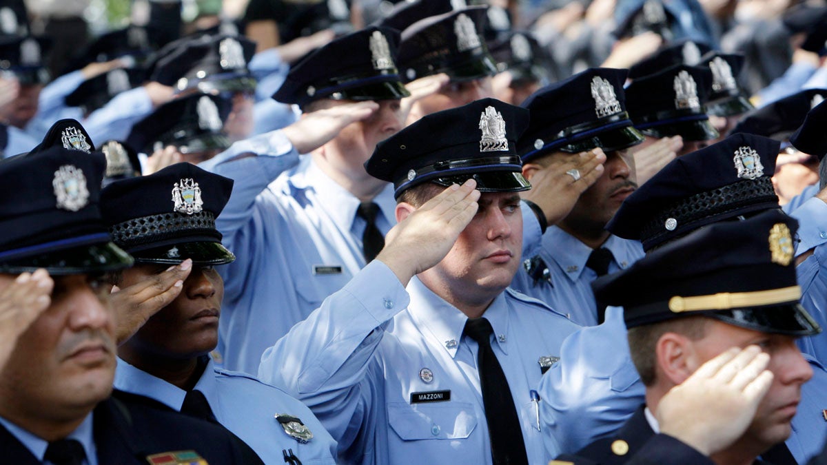 Police officers salute as the casket of casket of Philadelphia police Officer Sgt. Patrick McDonald, 30, as it is taken from Cathedral Basilica of Saints Peter and Paul after funeral services in Philadelphia in 2008. McDonald was fatally shot as he chased a man on foot after a traffic stop. (AP file photo)  