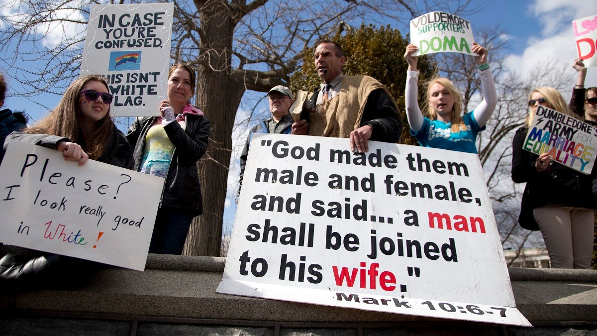  When the U.S. Supreme Court heard arguments in the Defense of Marriage Act (DOMA) case in March, both sides of the issue made their opinions known across the street. (AP Photo/Carolyn Kaster) 