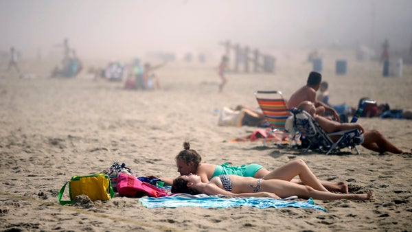  Sunbathers lay on the beach on a foggy afternoon in Belmar, N.J., ahead of the Fourth of July holiday. (Mel Evans/AP Photo, file) 