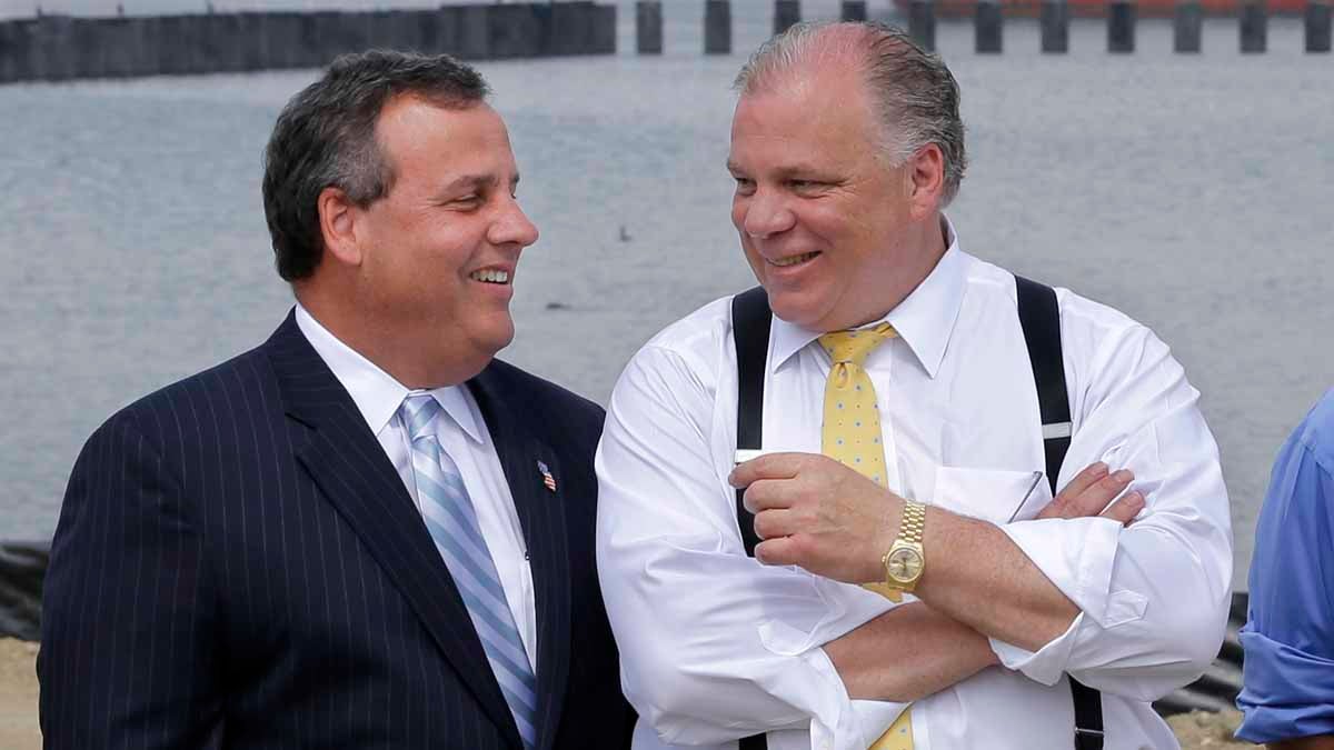 In this file photo, New Jersey Gov. Chris Christie, (left), shares a laugh with Senate President Steve Sweeney during a July event in Paulsboro.  (AP, file) 