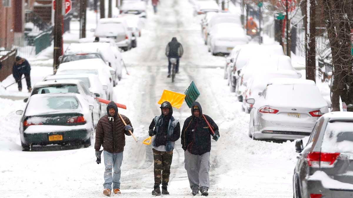  Men carry shovels as they walk on a snow covered road after a snowstorm in January in Hoboken, New Jersey. Gov. Chris Christie has proposed cutting the state's snow removal budget by half for next winters. (AP Photo/Julio Cortez) 
