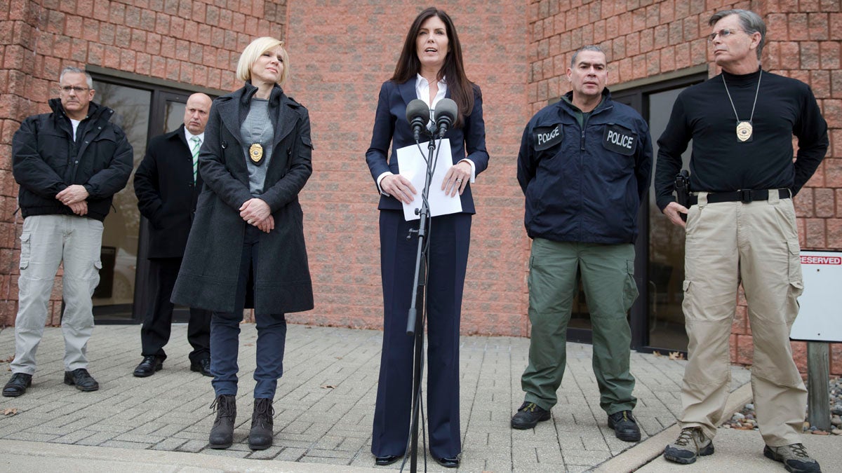  Attorney General Kathleen Kane, center, speaks during a news conference Wednesday in Philadelphia. Court documents released Wednesday show a grand jury has concluded there are reasonable grounds to charge Kane with perjury, false swearing, official oppression and obstruction after an investigation into leaks of secret grand jury material. Kane has proclaimed her innocence. (AP photo/Matt Rourke) 