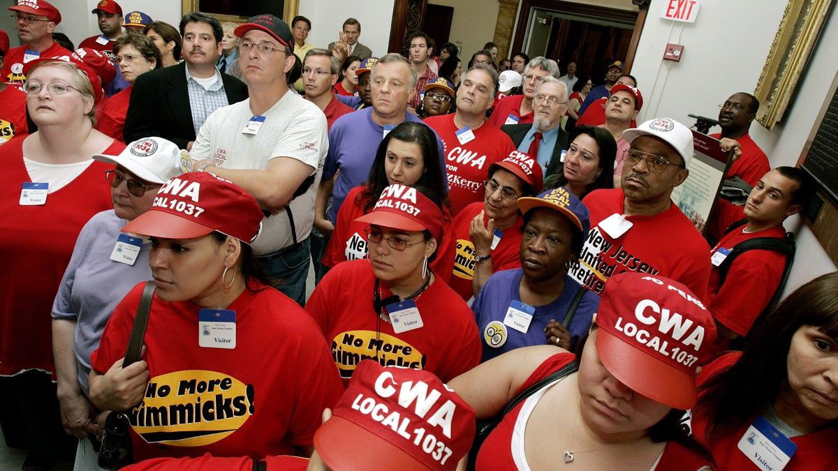  New Jersey workers furloughed by the shutdown of the state government over the budget impasse crowd into the hallway outside the office New Jersey Gov. Jon S. Corzine at the Statehouse in Trenton, July 5, 2006. (AP file photo) 