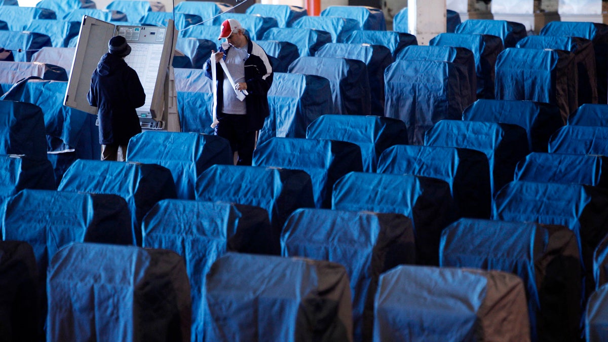 Technicians test voting machines in Philadelphia in 2010. The machines, now about a decade old, will not be replaced before the presidential primaries and general election this year. (AP file photo) 