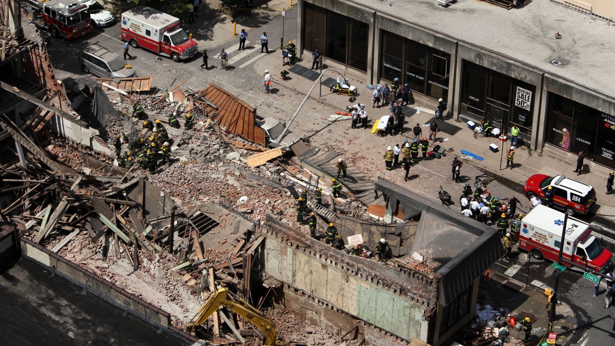  On June 5, 2013,  rescue personnel work the scene of a building collapse on Market Street in downtown Philadelphia that left six people dead and 13 injured. The owner of the building under demolition told jurors he 'realized something fell. I didn't know what it was.' (AP file photo) 