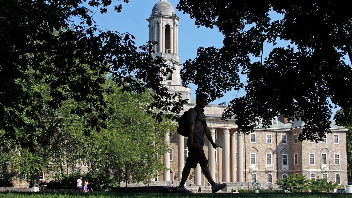 A Penn State University student walks across campus