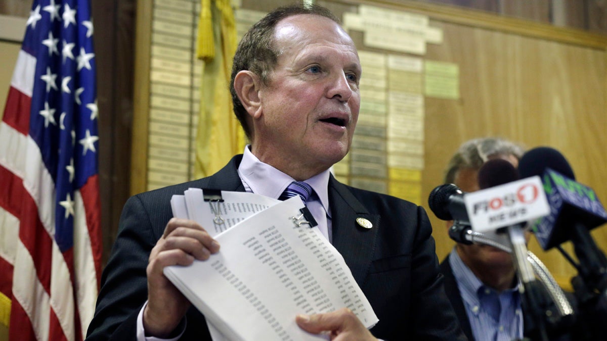  New Jersey Sen. Raymond J. Lesniak, D- Elizabeth, holds up petitions with more than 15,000 signatures against New Jersey Gov. Chris Christie's announced settlement with Exxon Mobil Corp. Lesniak called the Christie administration's proposed $225 million settlement of New Jersey's $8.9 billion claim for restoration of damage and destruction in the areas of Exxon Mobil's refineries in Linden, Bayonne and other facilities, the biggest corporate giveaway in New Jersey history. (AP Photo/Mel Evans) 