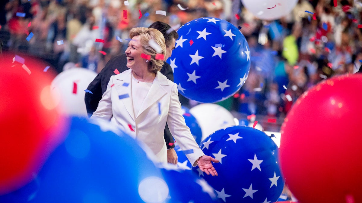 Democratic presidential candidate Hillary Clinton reacts to confetti and balloons as she stands on stage during the final day of the Democratic National Convention in Philadelphia