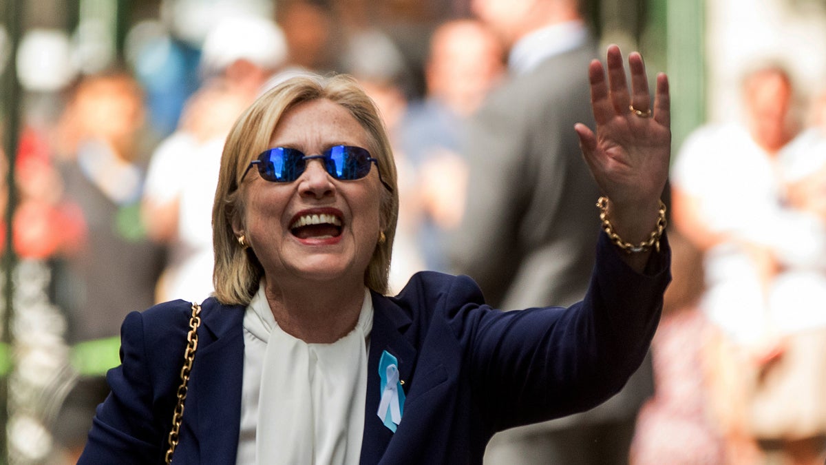 Democratic presidential candidate Hillary Clinton waves after leaving an apartment building Sunday in New York. Clinton's campaign said the Democratic presidential nominee left the 9/11 anniversary ceremony in New York early after feeling 