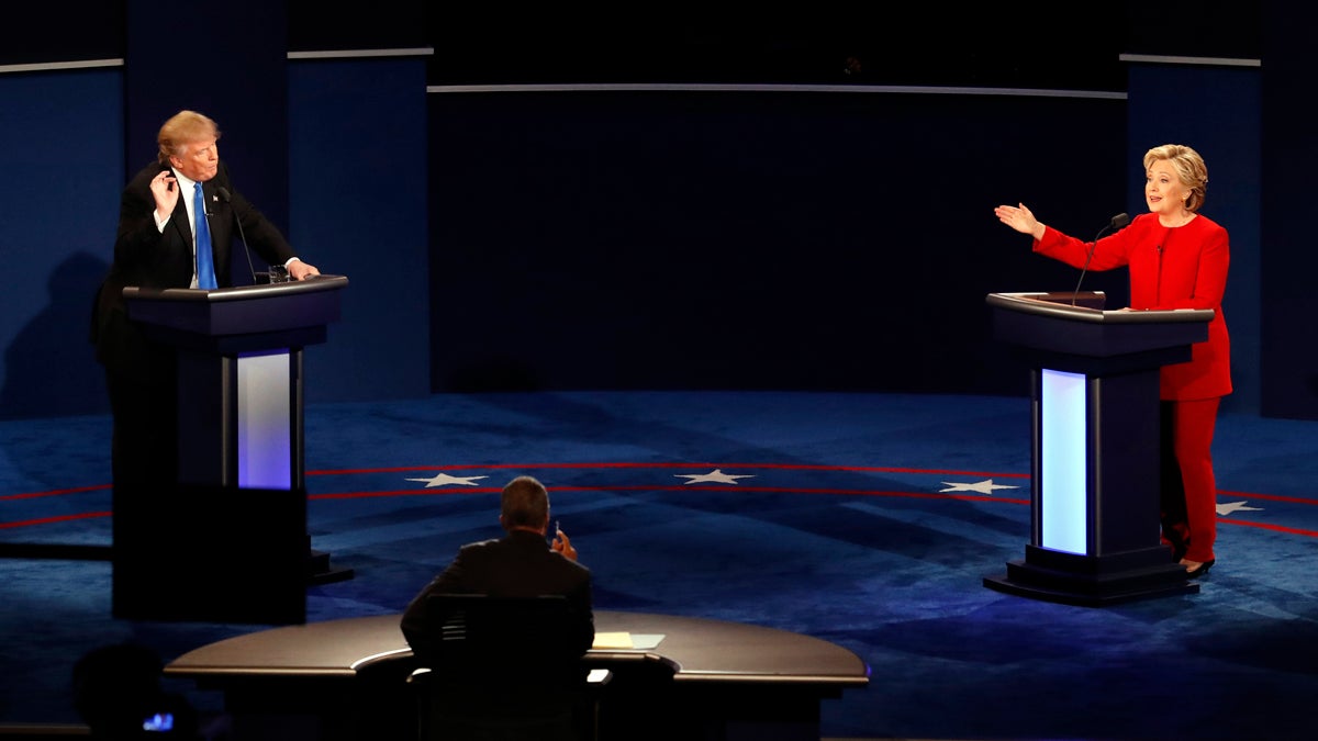 Republican presidential nominee Donald Trump and Democratic presidential nominee Hillary Clinton gesture during the presidential debate at Hofstra University in Hempstead
