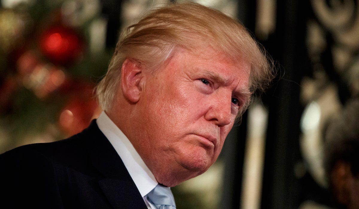 President-elect Donald Trump listens to a question as he speaks to reporters at Mar-a-Lago