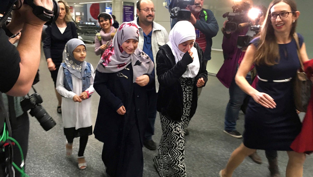  Eman Ali, 12, second from left, walks with her father, Ahmed Ali, center, after they arrived at San Francisco International Airport, Sunday, Feb. 5, 2017, in San Francisco. Joining them is her sister Salma Ali, 14, second from right, her cousin, left, who is unidentified, and their lawyer Katy Lewis, at right. Eman and her father were stuck for a week in Dijbouti after President Donald Trump signed an executive order temporarily banning people from seven predominantly Muslim nations from entering the United States. (AP Photo/Olga Rodriguez) 