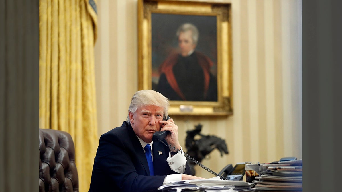  In this Saturday, Jan. 28, 2017 file photo, President Donald Trump speaks on the telephone with Australian Prime Minister Malcolm Turnbull in the Oval Office of the White House in Washington. In the background is a portrait of former President Andrew Jackson which Trump had installed in the first few days of his administration. (AP Photo/Alex Brandon, File) 