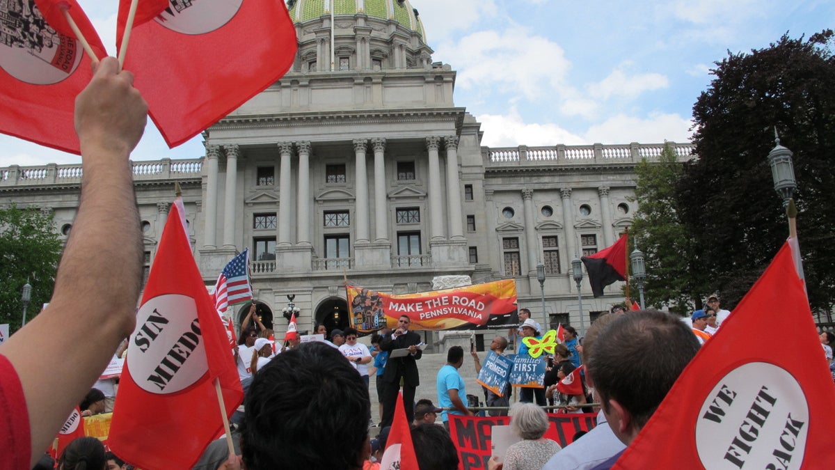  Demonstrators gather with more than 200 others  at a May Day rally on the steps of the Pennsylvania Capitol Monday in Harrisburg, Pennsylvania. Speaking is the Rev. Gregory Edwards of Allentown. (AP Photo/Marc Levy) 