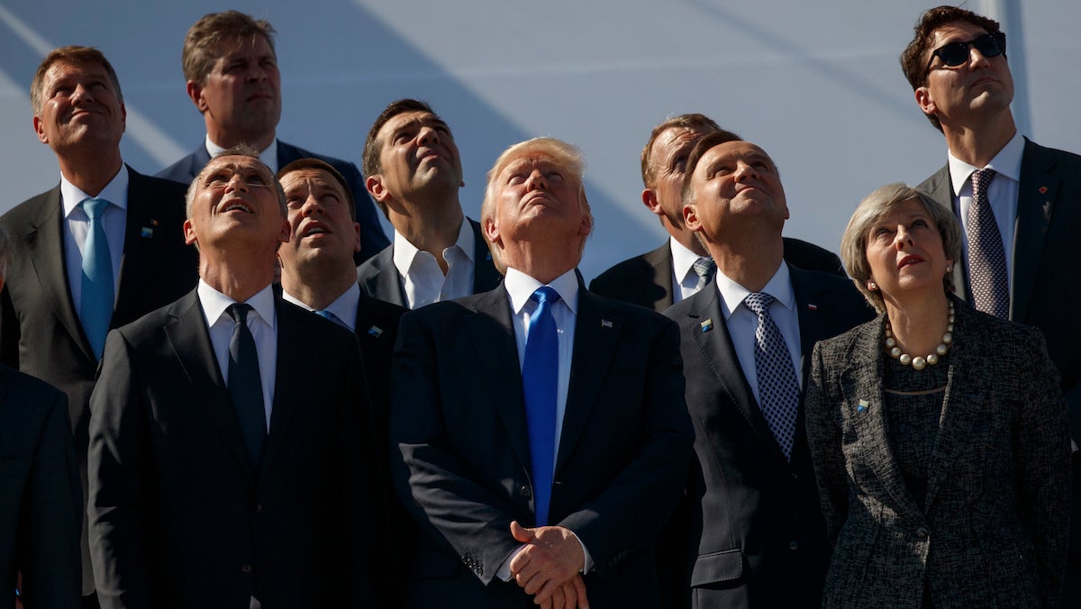  President Donald Trump and NATO leaders watch a flyover during a transfer ceremony at the new NATO headquarters, Thursday, May 25, 2017, in Brussels. (AP Photo/Evan Vucci) 