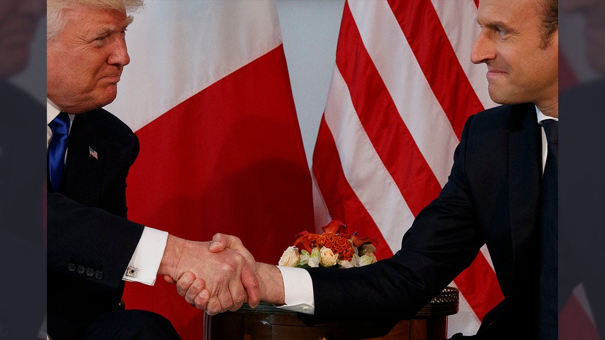  FILE - In this May 25, 2017 file photo, President Donald Trump shakes hands with French President Emmanuel Macron during a meeting at the U.S. Embassy in Brussels. Trump hasn’t done a lot of public speaking during his big trip abroad. But the president’s body language and that of those around him has spoken volumes. (AP Photo/Evan Vucci, File) 