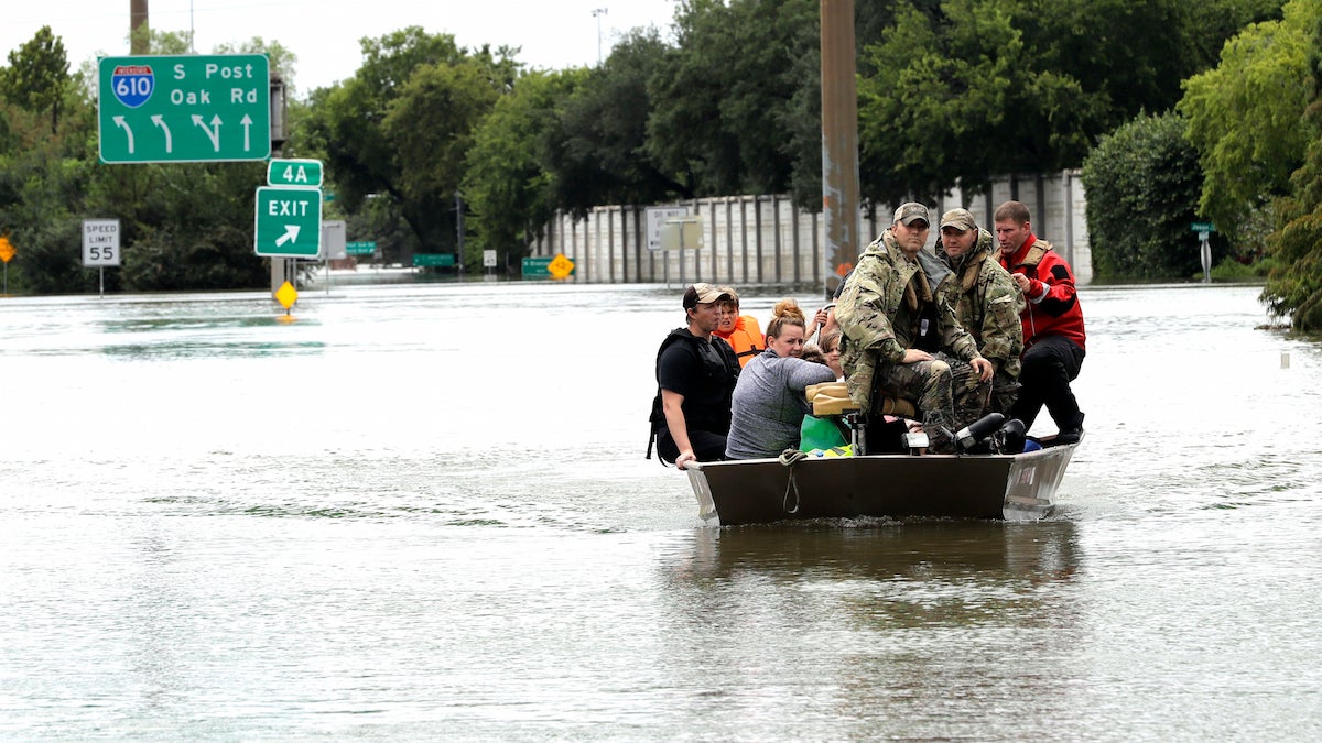 Residents are rescued from their homes surrounded by floodwaters from Tropical Storm Harvey on Sunday, Aug. 27, 2017, in Houston, Texas. (AP Photo/David J. Phillip)