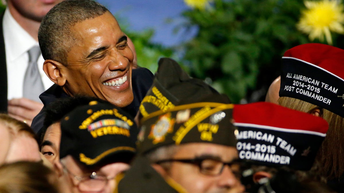  President Barack Obama shares a laugh with a veteran following his address at the Veterans of Foreign Wars National Convention at the David Lawrence Convention Center in Pittsburgh, Tuesday. (AP Photo/Gene J. Puskar) 