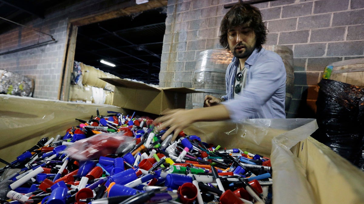 TerraCycle Inc. founder Tom Szaky sorts through a large box of marker pens in the company's Trenton