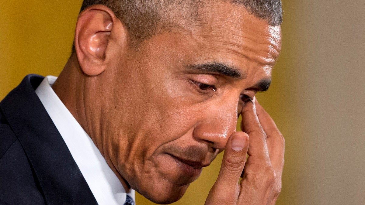  An emotional President Barack Obama pauses to wipe away tears as he recalled the 20 first-graders killed in 2012 at Sandy Hook Elementary School, while speaking in the East Room of the White House in Washington, Tuesday about steps his administration is taking to reduce gun violence. (AP Photo/Jacquelyn Martin 