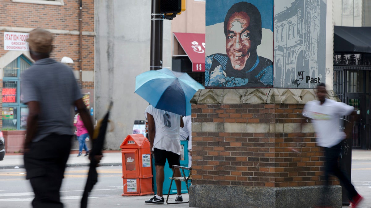  Pedestrians move past a mural depicting entertainer Bill Cosby on Market Street in Philadelphia. (AP Photo/Matt Rourke) 