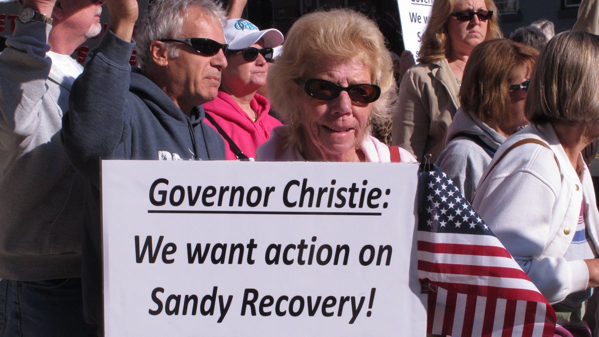  A woman holds a sign calling on New Jersey Gov. Chris Christie to help victims of Superstorm Sandy during a protest rally outside the New Jersey Statehouse in May. (Wayne Parry/AP Photo)  