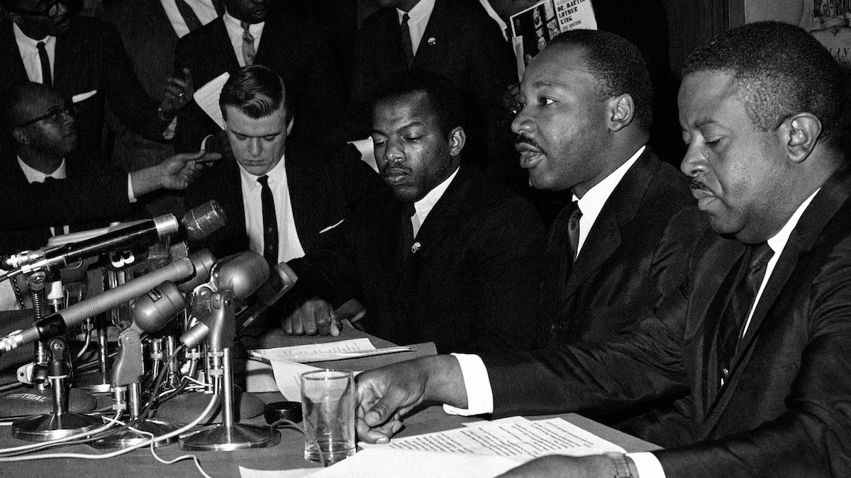  FILE - In this April 2, 1965 file photo, Dr. Martin Luther King Jr., second from right, speaks at a news conference next to John Lewis, to his left, chairman of the Student Nonviolent Coordinating Committee, in Baltimore. (AP Photo/William A. Smith, File) 