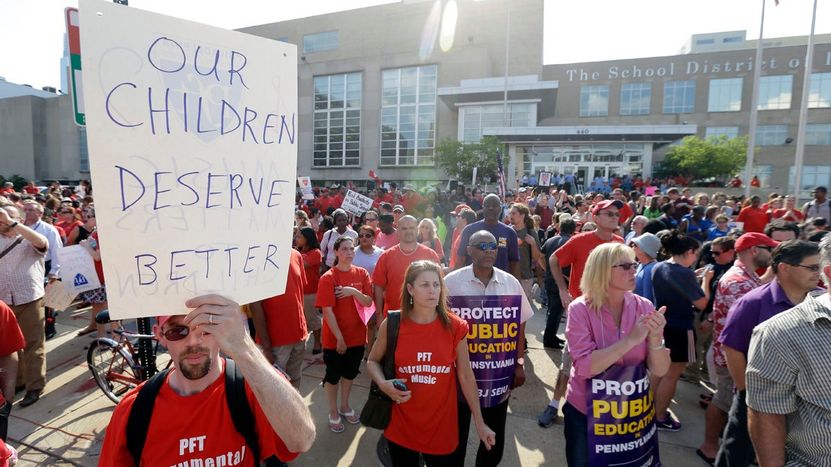  Teachers and other personnel from the Philadelphia School District protest  massive cuts in 2013. An arbitrator has ruled the district was wrong to ignore seniority when rehiring guidance counselors it laid off at that time. (AP file photo) 