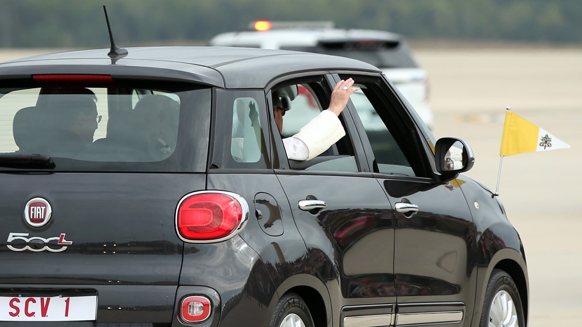 Pope Francis waves from a Fiat 500 as his motorcade departs from Andrews Air Force Base. (Andrew Harnik/AP Photo) 