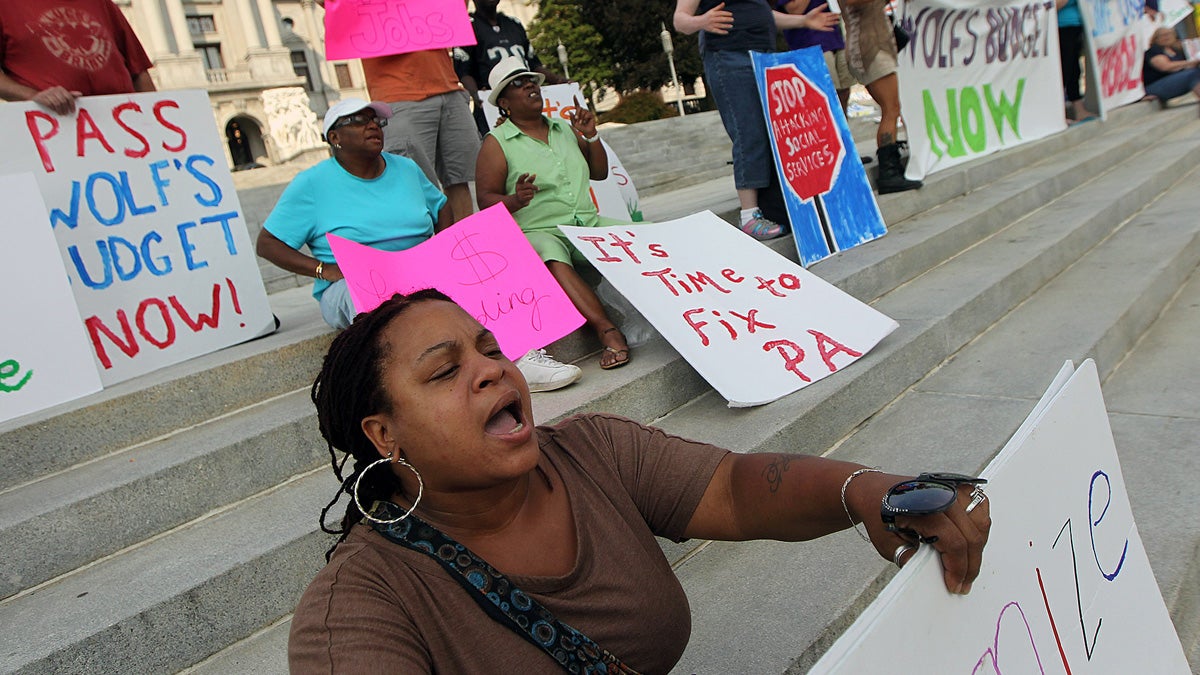  Dawn Hawkins of Philadelphia belts out a chant as she demonstrates on the steps of the state Capitol in favor of Pennsylvania Gov. Tom Wolf's budget plan in Harrisburg Tuesday. Wolf has vetoed a Republican budget plan and a bill to privatize Pennsylvania's state-run liquor system. (AP Photo/Chris Knight) 