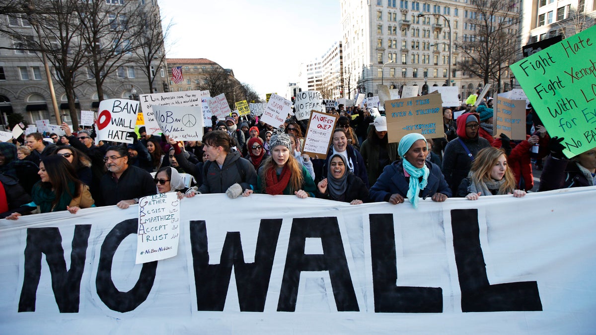 Demonstrators march along Pennsylvania Avenue past the Trump International Hotel in Washington Saturday to protest the immigration policies of President Donald Trump. New Jersey Senate Monday passed two measures Monday objecting to the president's plans to ban immigrants from seven Muslim-majority countries and build a wall between the U.S. and Mexico. (AP Photo/Manuel Balce Ceneta)