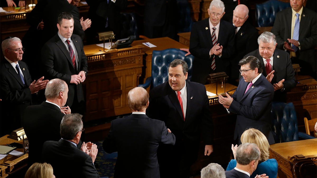  New Jersey Gov. Chris Christie, center, arrives to deliver his State Of The State address, Tuesdayin Trenton, N.J. (AP Photo/Mel Evans) 