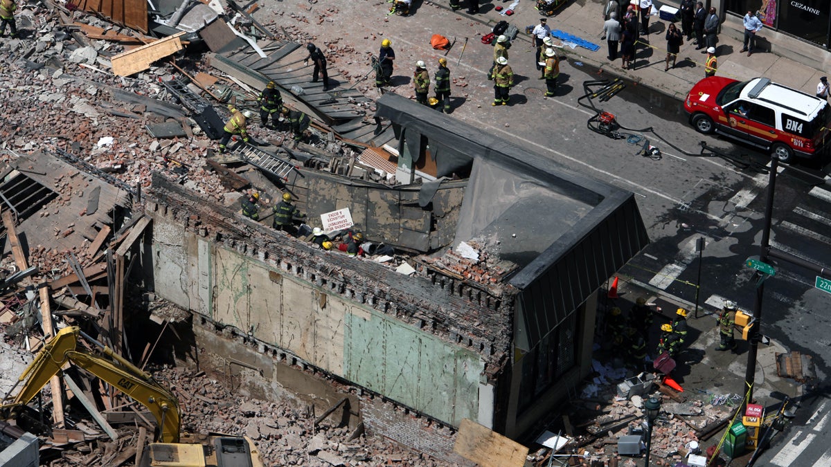  After the 2013 collapse, rescue personnel work the scene on Market Street in downtown Philadelphia that left six people dead. General contractor Griffin Campbell is standing trial on third-degree murder charges in the deaths of six people who perished in the collapse. (AP file photo) 