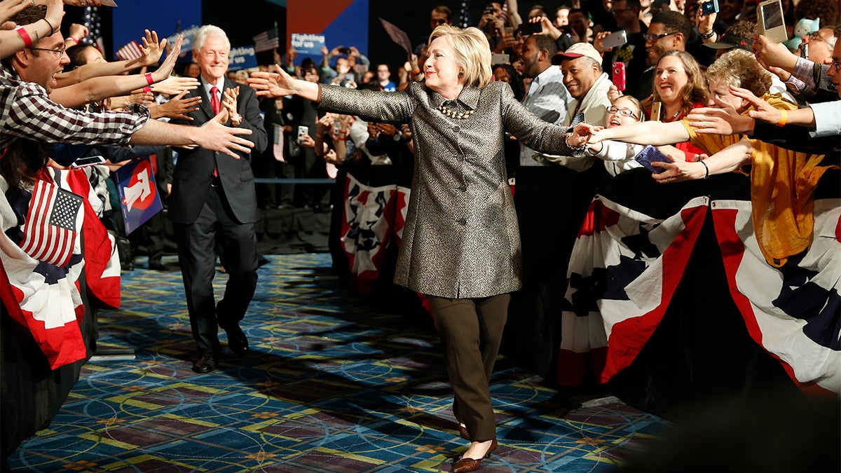 Democratic presidential candidate Hillary Clinton and Former President Bill Clinton move to the stage at her presidential primary election night rally