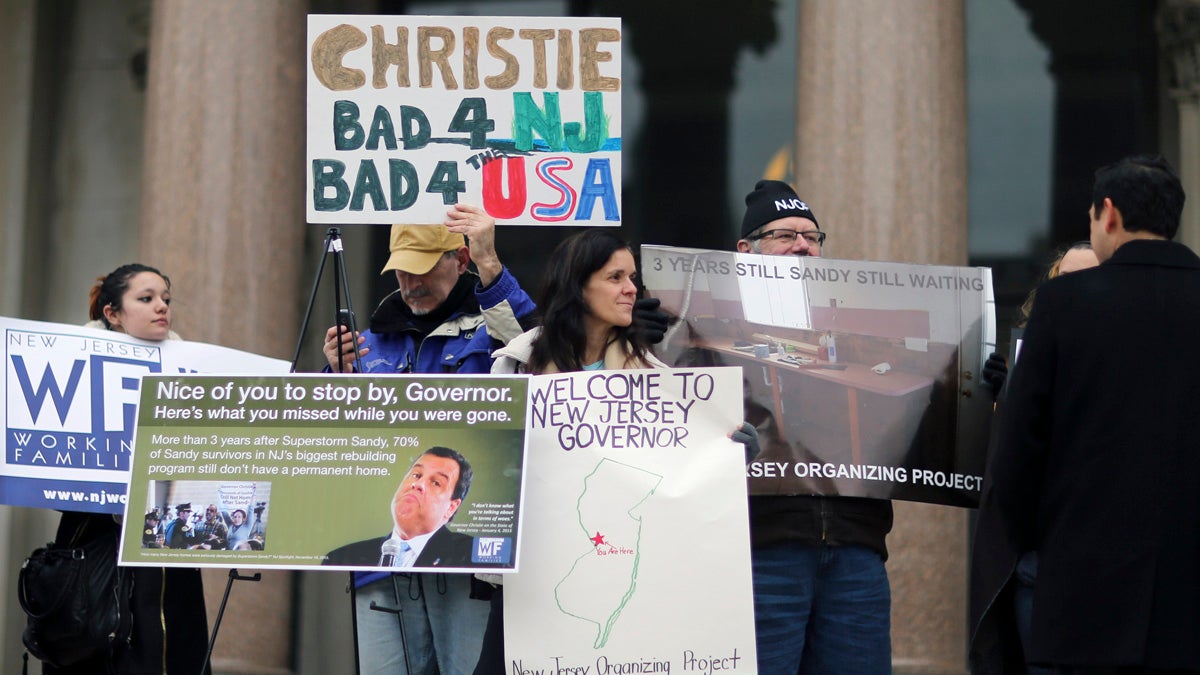  A group of people gathers to protest outside the Statehouse before Gov. Chris Christie delivers his State Of The State address Tuesday in Trenton. (AP Photo/Mel Evans) 