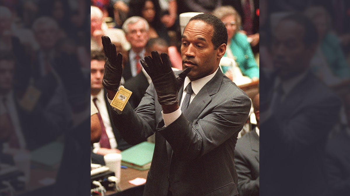  O.J. Simpson holds up his hands before the jury after putting on a new pair of gloves similar to the infamous 