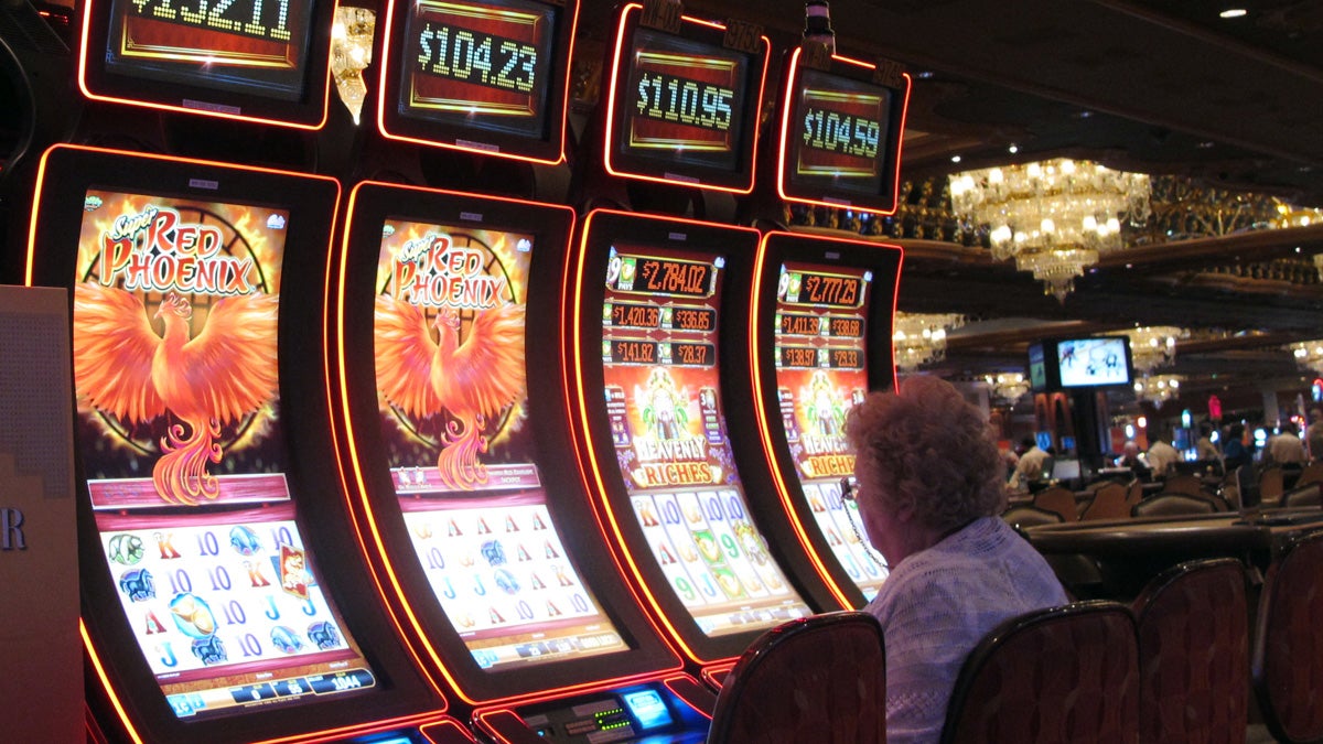 A gambler tries her luck at the slot machines at the Trump Taj Mahal casino in Atlantic City