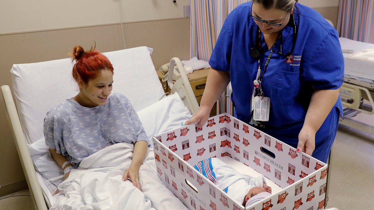  In this May 6, 2016, file photo, Keyshla Rivera smiles at her newborn son Jesus as registered nurse Christine Weick demonstrates a baby box before her discharge from Temple University Hospital in Philadelphia on Friday, May 6, 2016. (Matt Rourke/AP Photo, file) 