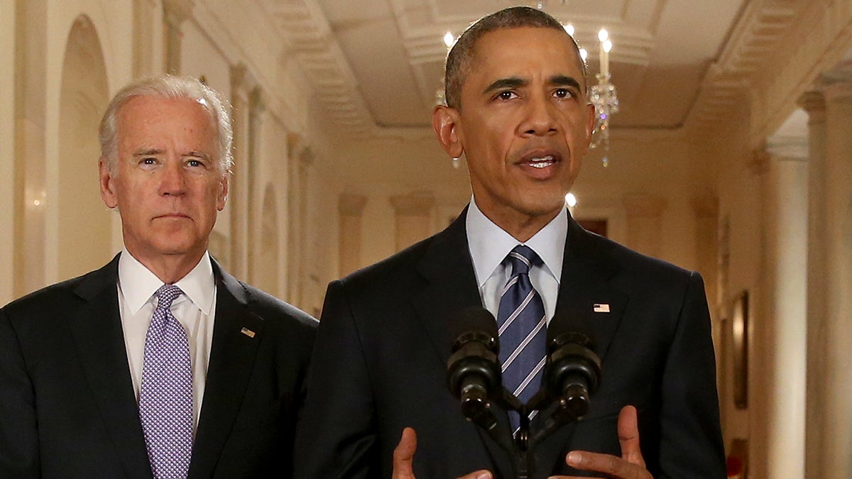  President Barack Obama, standing with Vice President Joe Biden, delivers remarks in the East Room of the White House in Washington, Tuesday, July 14, 2015, after an Iran nuclear deal is reached. After 18 days of intense and often fractious negotiation, diplomats Tuesday declared that world powers and Iran had struck a landmark deal to curb Iran's nuclear program in exchange for billions of dollars in relief from international sanctions. (Andrew Harnik/AP Photo, Pool) 