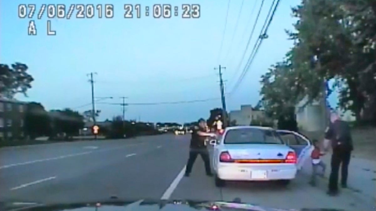  In this image made from July 6, 2016, video captured by a camera in the squad car of St. Anthony Police officer Jeronimo Yanez, the Minnesota police officer is shown after shooting into the vehicle at Philando Castile during a traffic stop in Falcon Heights, Minn., as the 4-year-old daughter of Castile's girlfriend, Diamond Reynolds, starts to get out of the car and is grabbed by an officer. The video was made public by the Minnesota Bureau of Criminal Apprehension and the Ramsey County Attorney's Office, Tuesday, June 20, 2017, just days after the officer was acquitted on all counts in the case. (St. Anthony Police Department via AP) 