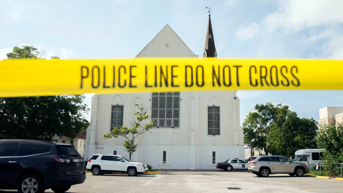  In this June 19, 2015 file photo, police tape surrounds the parking lot behind the AME Emanuel Church as FBI forensic experts work the crime scene, in Charleston, S.C. (Stephen B. Morton/AP Photo, File) 