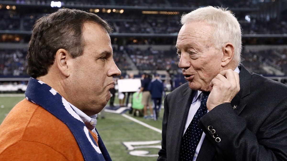  New Jersey Gov. Chris Christie, (left), talks with Dallas Cowboys team owner Jerry Jones, on the field as the teams warm up before an NFL football game against the Indianapolis Colts, Sunday, Dec. 21, 2014, in Arlington, Texas. (Brandon Wade/AP Photo) 