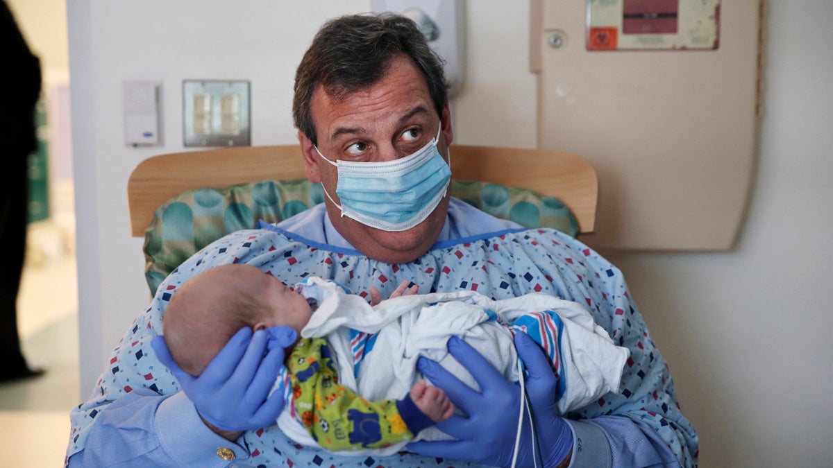 In this Tuesday, Dec. 6, 2016, file photo, New Jersey Gov. Chris Christie holds a 49-day-old baby boy being treated for neonatal drug withdrawal after his mother took opioids during pregnancy, at the Neonatal Intensive Care Unit at Jersey Shore University Medical Center in Neptune Township, N.J. (Mel Evans/AP Photo)   