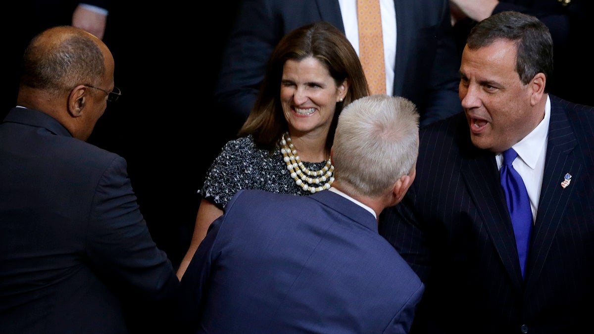  New Jersey Gov. Chris Christie (right) and  first lady Mary Pat Christie, are greeted upon arrival for the governor's State of the State address Tuesday in Trenton. (Mel Evans/AP Photo) 