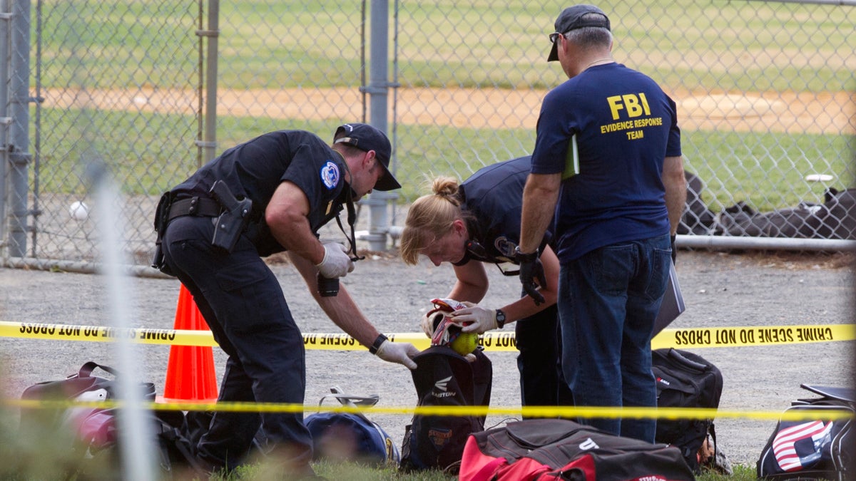  An FBI Evidence Response team inspects the contents of one of the many bags left at the scene of a shooting in Alexandria, Va., Wednesday, June 14, 2017, involving House Majority Whip Steve Scalise of La., and others, during a congressional baseball practice. (Cliff Owen/AP Photo) 
